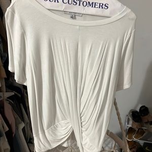 White shirt what crosses in the front. It is a long shirt.